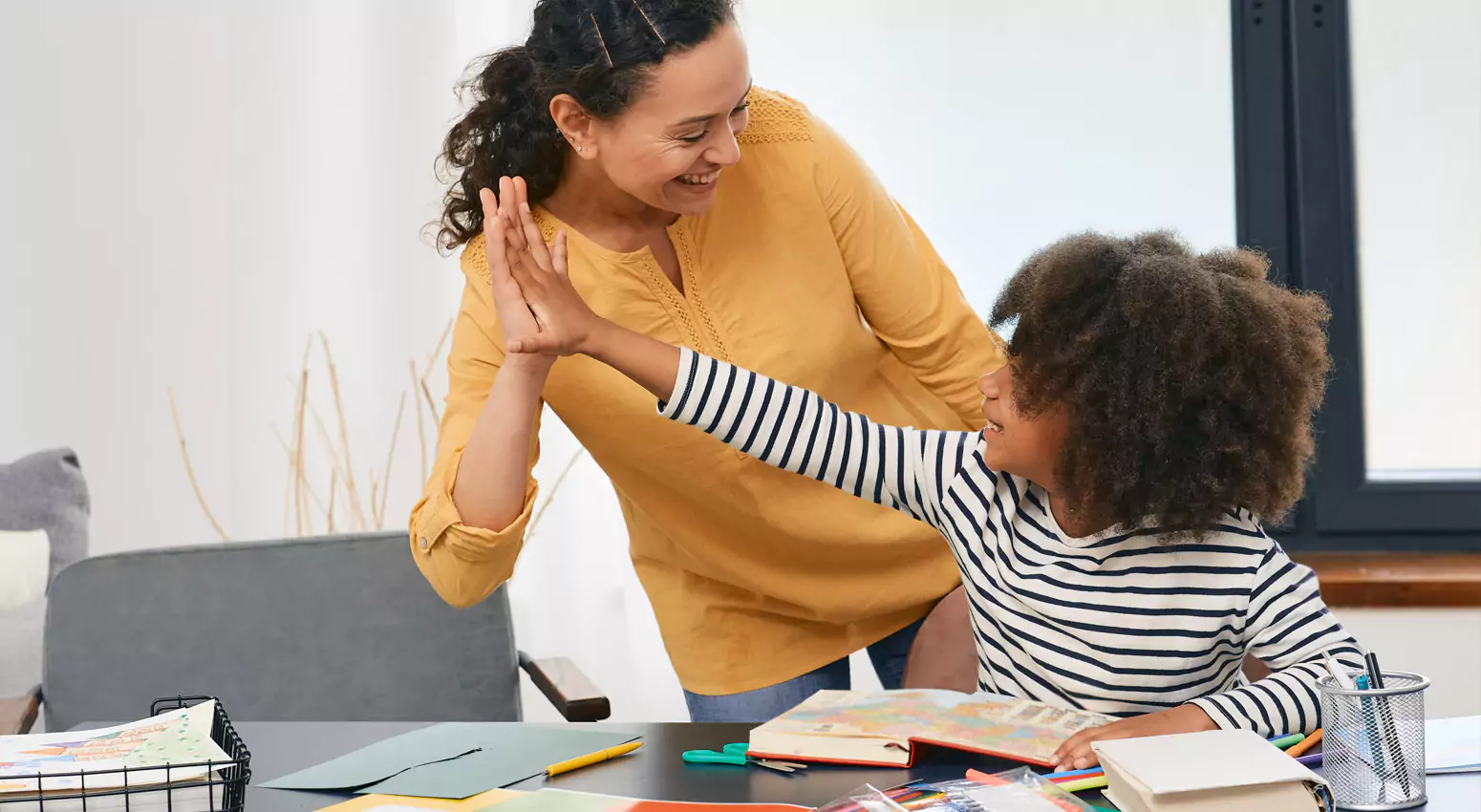 Therapist and student high fiving